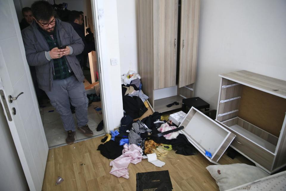 A plainclothes police officer walks inside the flat where a suspect of New Year's Day nightclub attack was arrested during an overnight police raid, in Istanbul, Tuesday, Jan. 17, 2017. Turkish police said they captured the gunman who carried out the deadly New Year's nightclub attack in Istanbul, with officials saying Tuesday that he's an Uzbekistan national who trained in Afghanistan and confessed to the massacre. (AP Photo/Lefteris Pitarakis)