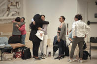 Attendees cry and hug during a sexual harassment prevention class for nannies and housekeepers on Saturday, April 27, 2024, in the Brooklyn borough of New York. Nannies, housekeepers, and home care workers are excluded from many federal workplace protections in the United States, and the private, home-based nature of the work means abuse tends to happen behind closed doors. (AP Photo/Andres Kudacki)