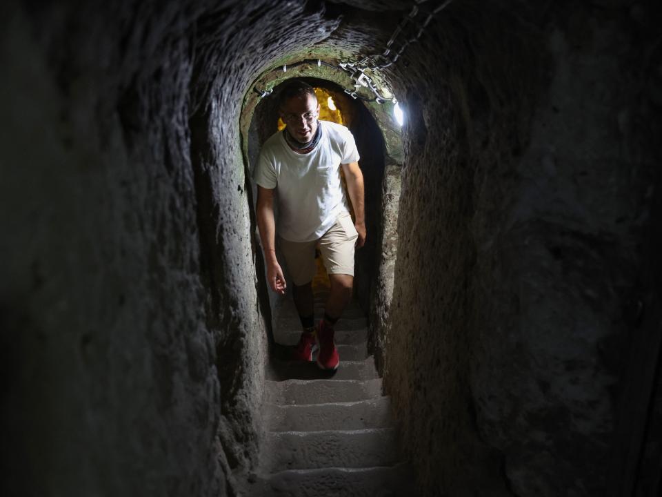 A man walks through a tunnel in Derinkuyu.