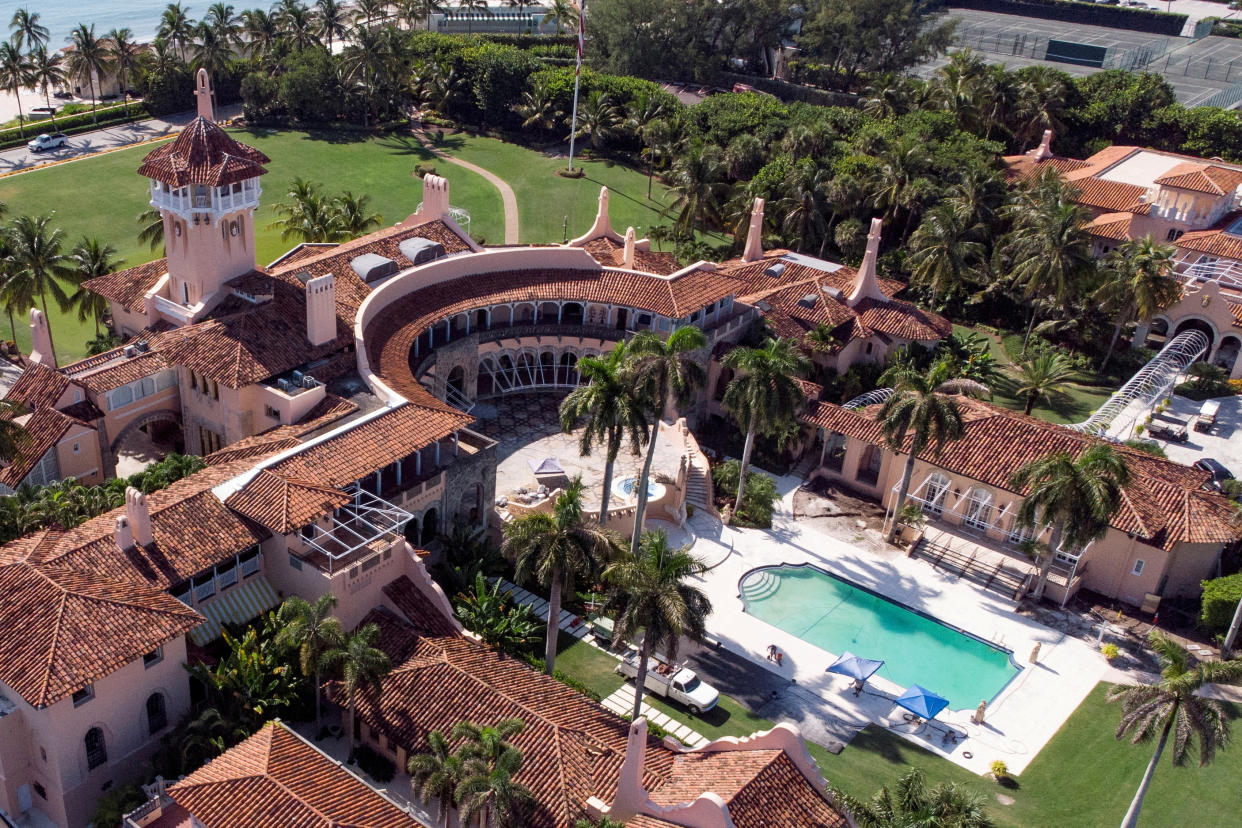 An aerial view of former U.S. President Donald Trump's Mar-a-Lago resort shows a complex and tower surrounding a pool.