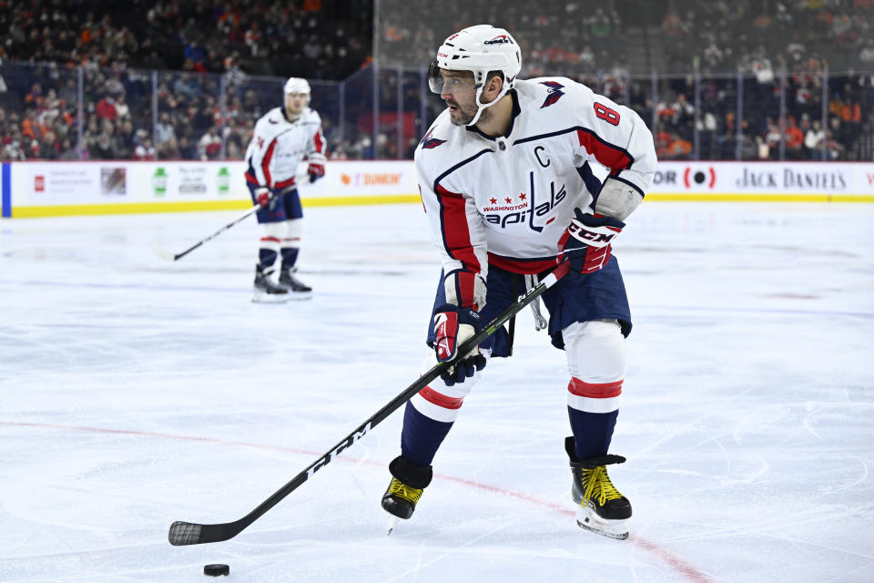 Washington Capitals' Alex Ovechkin looks to pass the puck during the first period of an NHL hockey game against the Philadelphia Flyers, Saturday, Feb. 26, 2022, in Philadelphia. (AP Photo/Derik Hamilton)