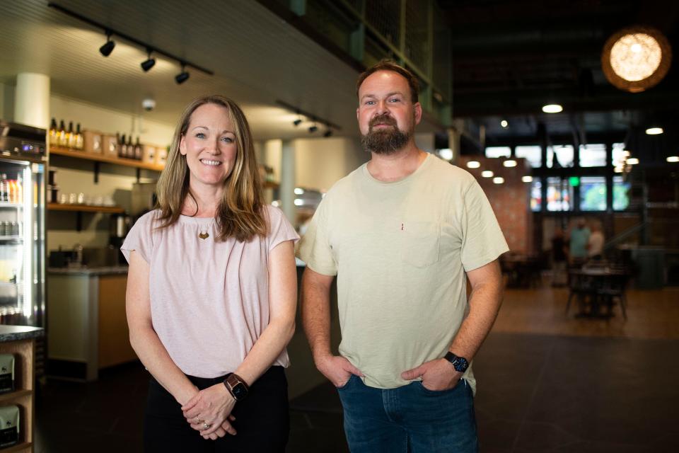 Frothy Monkey co-owners Jennifer Sheets and Ryan Pruitt pose inside the business's new downtown Knoxville location, which spans roughly 4,000 square feet across the Kress Building at 419 S. Gay St. The renovated space includes a staircase leading to a new mezzanine level and views of the graffitied Strong Alley between Gay Street and Market Square.