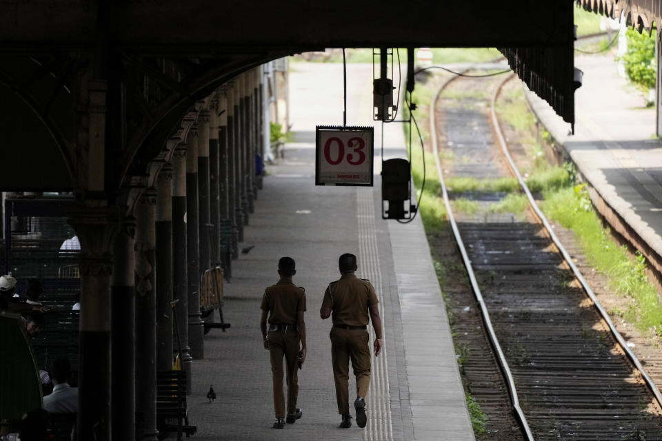 Police officers patrol in a railway station during a railway union strike in Colombo, Sri Lanka, Wednesday, July 10, 2024. (AP Photo/Eranga Jayawardena)