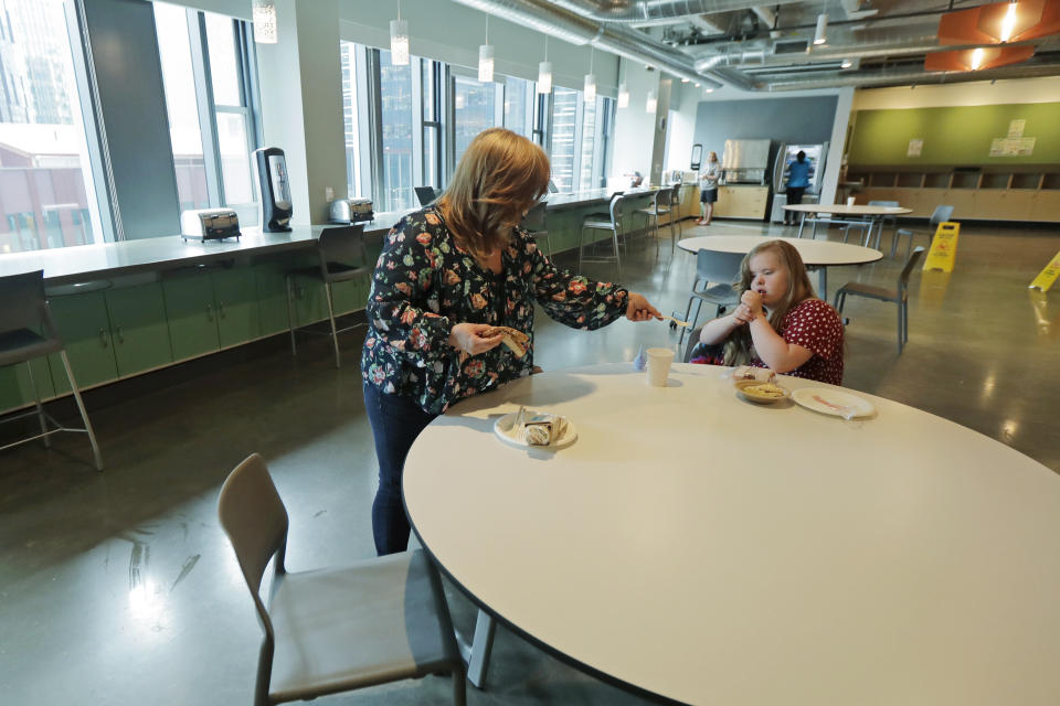 Connie Wade, left, prepares to eat lunch with her daughter Emilyanne, 12, Wednesday, June 17, 2020, at Mary's Place, a family homeless shelter located inside an Amazon corporate building on the tech giant's Seattle campus. The facility is home to the Popsicle Place shelter program, an initiative to address the needs of homeless children with life-threatening health conditions. (AP Photo/Ted S. Warren)