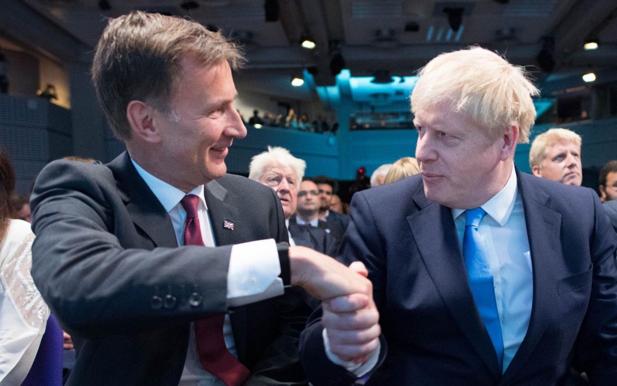 Jeremy Hunt and Boris Johnson shake hands at the end of the Tory leadership contest in June 2019  - Stefan Rousseau/AFP