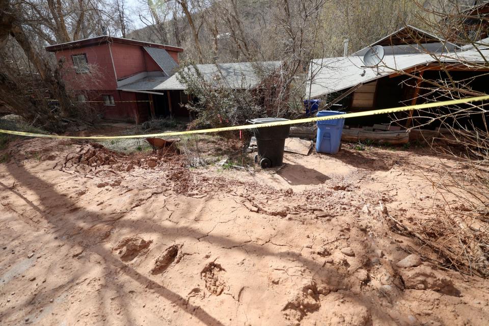 Two houses are roped off after a mudslide in Emigration Creek in Emigration Canyon on Tuesday, May 2, 2023.