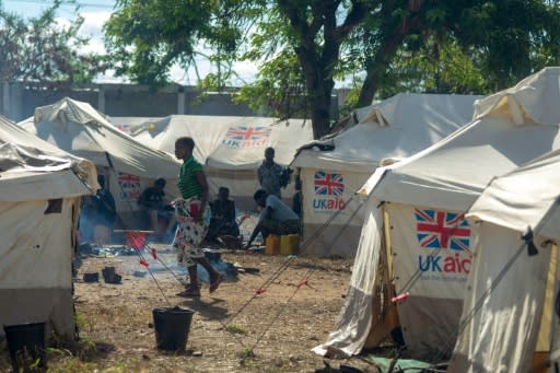 A woman walks through a camp for displaced people in Nhamatanda district in Mozambique on April 15, 2019 where 8,465 people have been displaced