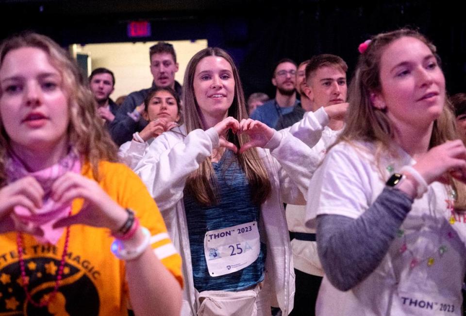 Dancer from Tri Sig Skylar McCullough makes a heart as she does the line dance during the Penn State IFC/Panhellenic Dance Marathon on Saturday Feb. 18, 2023 at the Bryce Jordan Center.