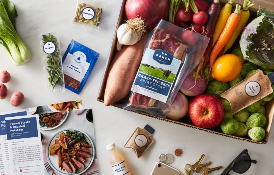 Blue Apron meal kit, containing ingredients like beef, carrots, onions, Brussels sprouts, and potatoes