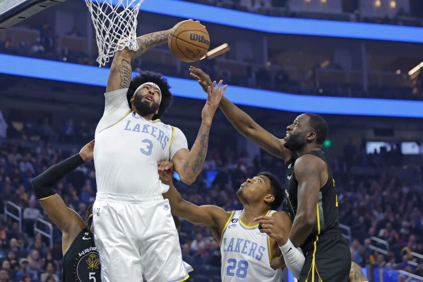 Los Angeles Lakers forward Anthony Davis (3) rebounds the ball over Golden State Warriors.