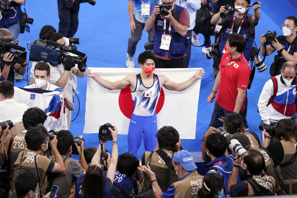 Daiki Hashimoto, of Japan, celebrates after winning the gold medal in the artistic gymnastics men's all-around final at the 2020 Summer Olympics, Wednesday, July 28, 2021, in Tokyo. (AP Photo/Gregory Bull)