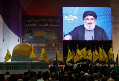 Lebanon's Hezbollah leader Sayyed Hassan Nasrallah addresses his supporters via a screen during a rally marking Al-Quds day in Beirut's southern suburbs, Lebanon June 23, 2017. REUTERS/Aziz Taher