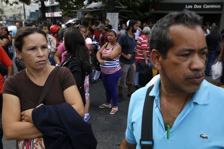 People try to find other modes of transportation after subway services were cut off during a blackout in Caracas June 27, 2014. REUTERS/Carlos Garcia Rawlins