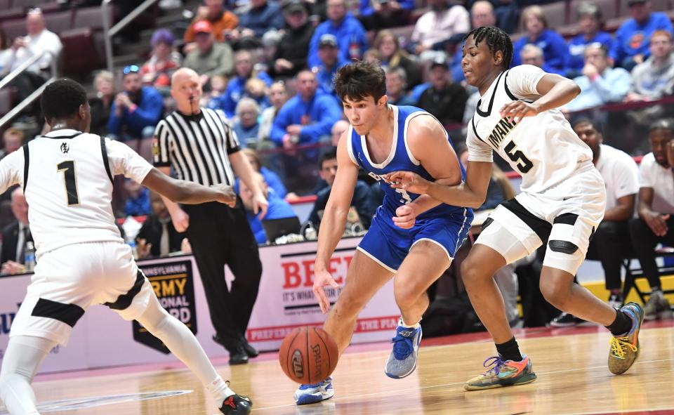 Berlin Brothersvalley's Craig Jarvis drives between Imani Christian's R.J. Sledge (1) and Nate Brazil (5) in the PIAA Class 1A boys' basketball championship, March 21, at the Giant Center in Hershey.