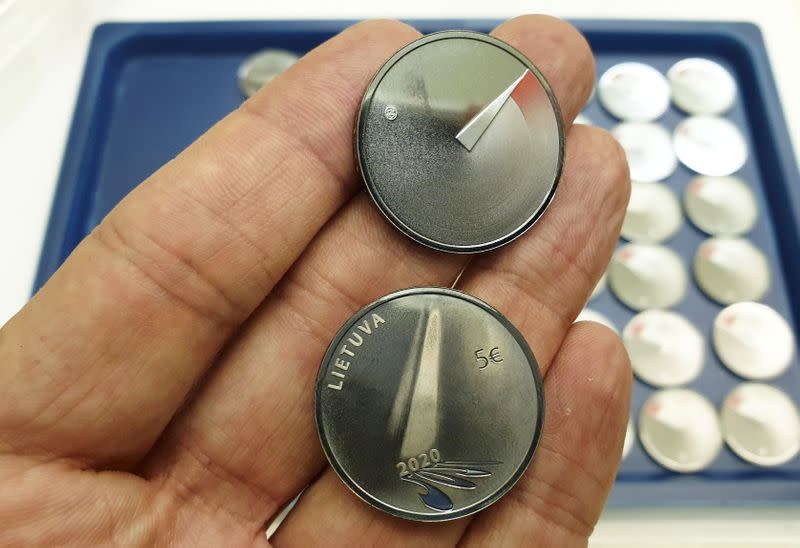 A man shows 5 Euros nominal silver coins, minted to mark the coronavirus disease (COVID-19) outbreak in Vilnius