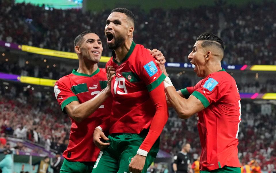 Morocco's Youssef En-Nesyri, center, celebrates after scoring his side's first goal during the World Cup - AP