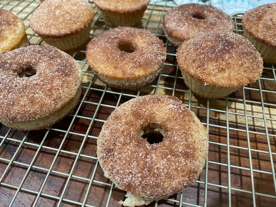 Cinnamon donuts on a rack.