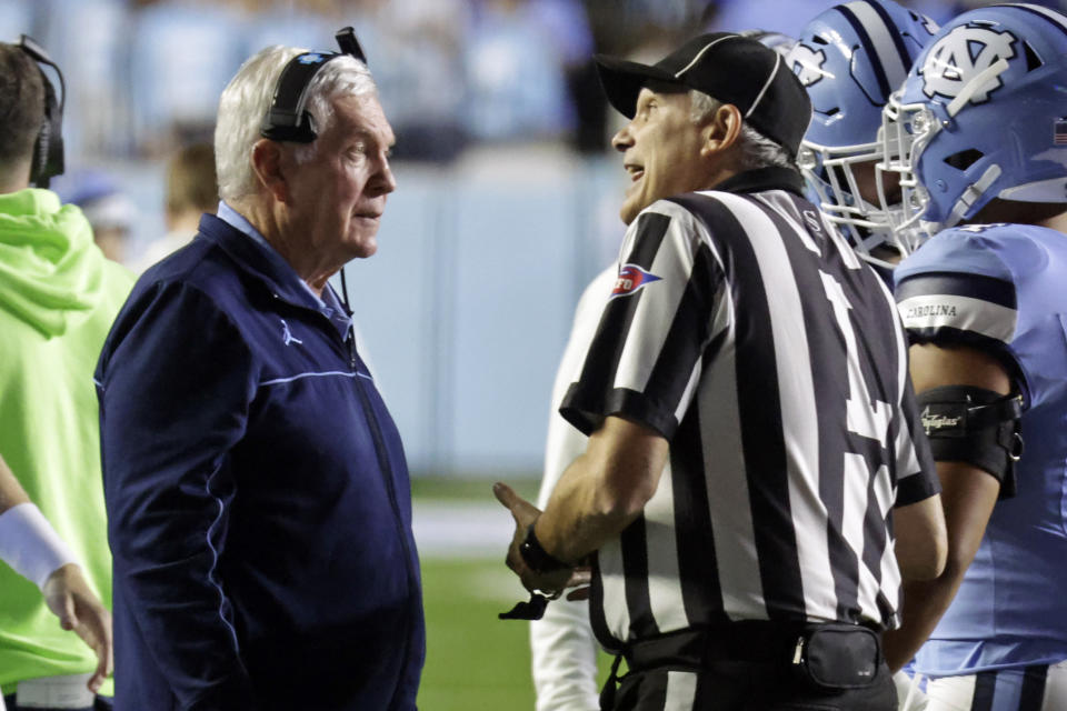 North Carolina coach Mack Brown discusses a call with an official during the second half of the team's NCAA college football game against Miami, Saturday, Oct. 14, 2023, in Chapel Hill, N.C. (AP Photo/Chris Seward)