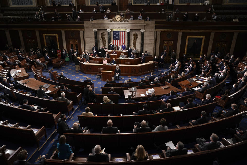 FILE - In this Jan. 6, 2021, photo, the Republican side, right, in the House chamber is seen as Speaker of the House Nancy Pelosi, D-Calif., and Vice President Mike Pence officiate as a joint session of the House and Senate convenes to count the Electoral College votes cast in November's election, at the Capitol in Washington. State attorneys general and the House committee investigating the Jan. 6 attack on the Capitol are digging deeper into the role that fake slates of electors played in the desperate effort by former President Donald Trump to cling to power after his defeat in the 2020 election. (AP Photo/J. Scott Applewhite, Pool, File)