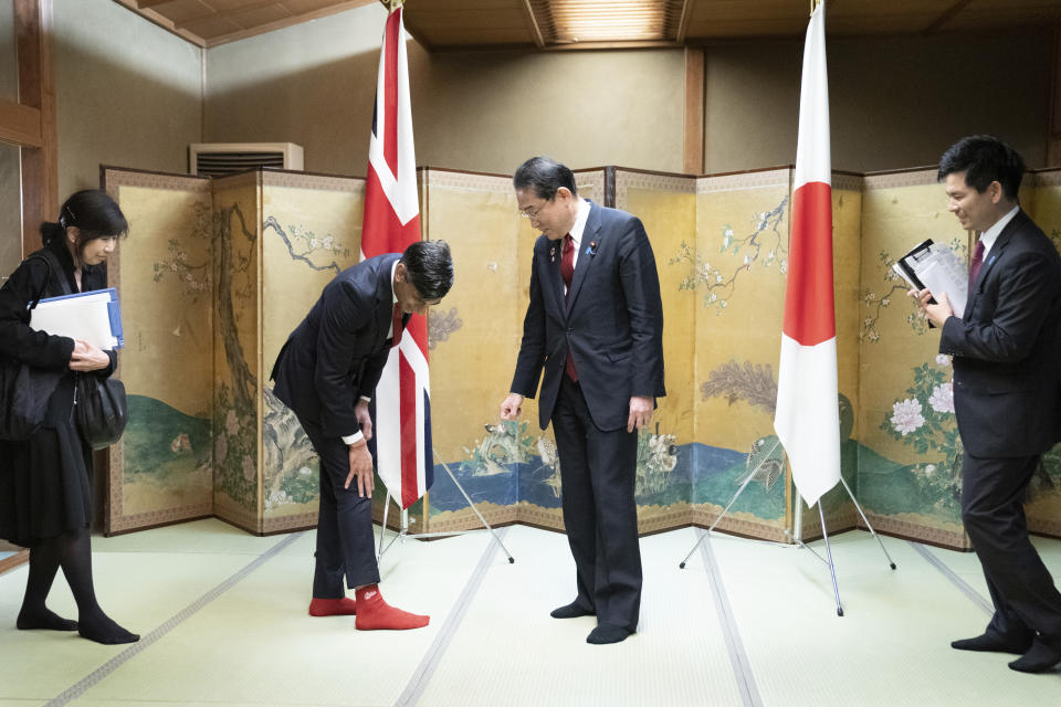 XFP British Prime Minister Rishi Sunak shows off his socks to Japanese Prime Minister Fumio Kishida, which has the name of Kishida's favorite baseball team, Hiroshima Toyo Carp, on them, during their bilateral meeting in Hiroshima ahead of the G7 Summit in Japan, Thursday May 18, 2023. (Stefan Rousseau, Pool via AP)