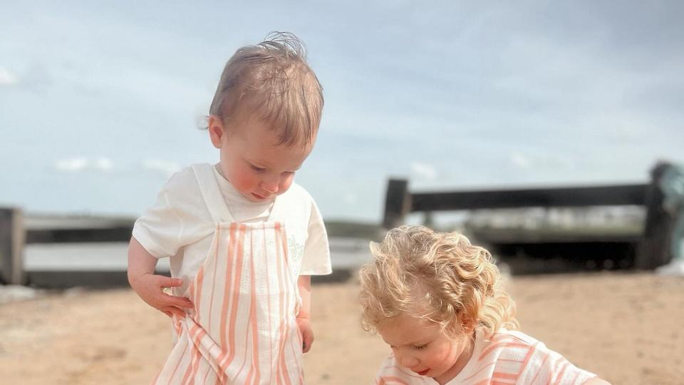 two young sisters playing on beach 