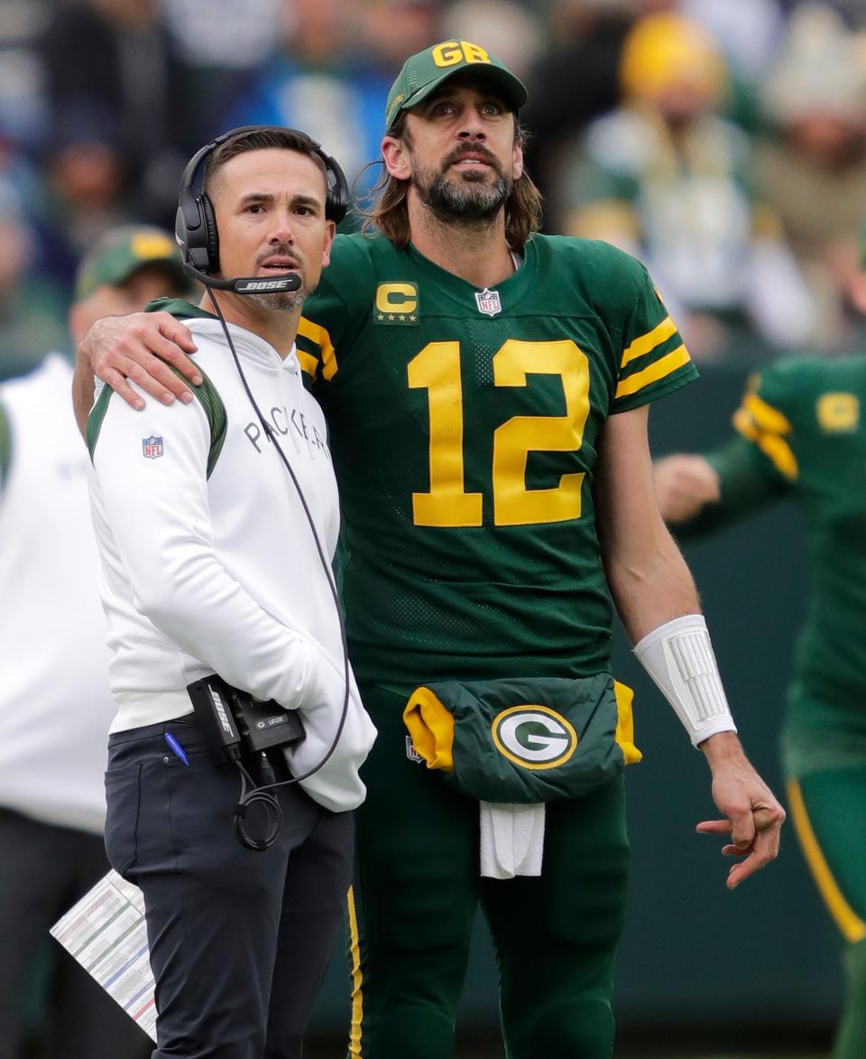 Green Bay Packers coach Matt LaFleur and quarterback Aaron Rodgers stand arm-in-arm late in the team's Oct. 24 victory over the Washington Football Team at Lambeau Field in Green Bay.