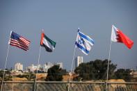 The flags of the U.S., United Arab Emirates, Israel and Bahrain flutter along a road in Netanya