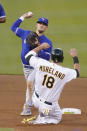 Toronto Blue Jays' Cavan Biggio, top, throws to first base after forcing Oakland Athletics' Mitch Moreland (18) out at second base on a double play hit into by Vimael Machin during the fourth inning of a baseball game in Oakland, Calif., Tuesday, May 4, 2021. (AP Photo/Jeff Chiu)