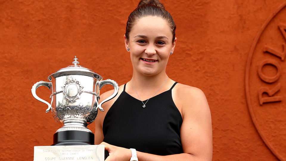 Ash Barty is pictured here with the first grand slam trophy of her tennis career.