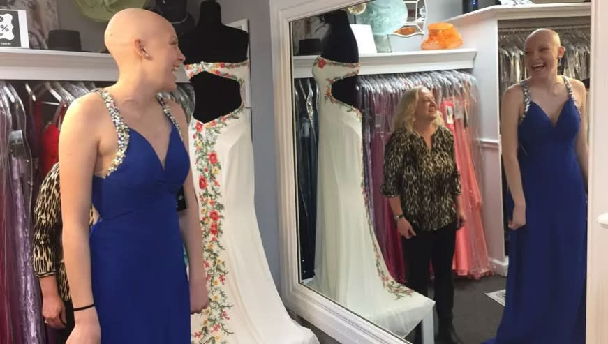 White tries on a prom dress at Lux Boutique. (Photo: Dustin Levy/Evening Sun)