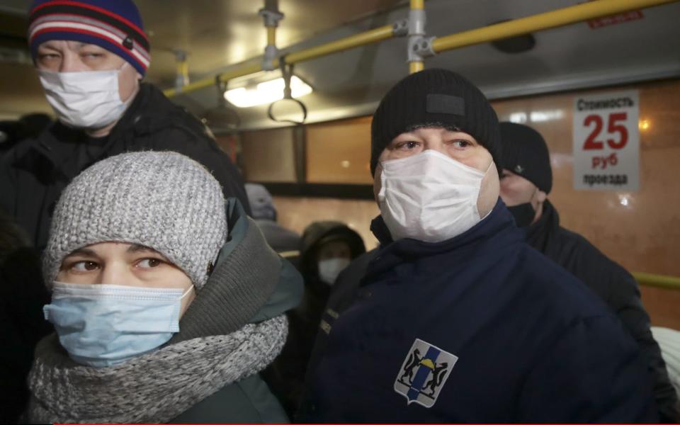 Russian police raid a bus in Novosibirsk to enforce compliance with face mask rules - Kirill Kukhmar/TASS