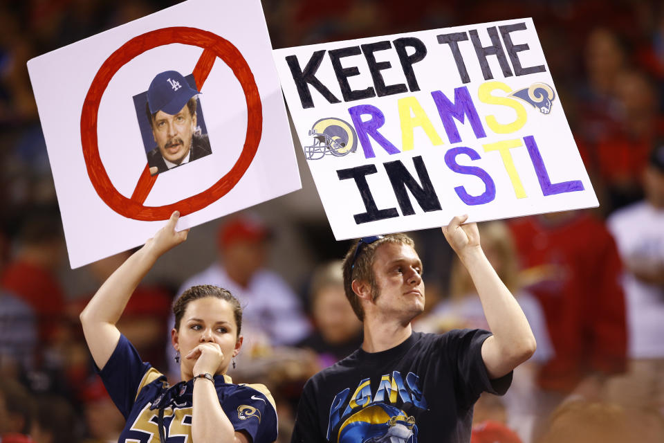 Foto de archivo del 29 de mayo de 2015 en la que fanáticos muestran carteles de apoyo para que los Rams de San Luis sigan en la ciudad durante un partido de béisbol entre los Cardenales de San Luis y los Dodgers de Los Ángeles. (AP Foto/Billy Hurst)