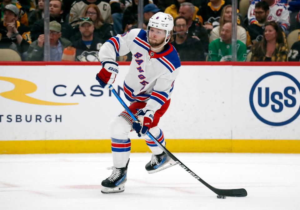 Mar 16, 2024; Pittsburgh, Pennsylvania, USA; New York Rangers defenseman Zac Jones (6) passes the puck against the Pittsburgh Penguins during the first period at PPG Paints Arena. New York won 7-4.