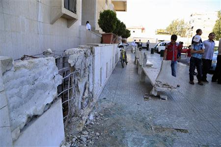 Residents inspect damage from mortar bombs that landed in Badr al-Din al-Hussein school complex, a religious jurisprudence college in Bab Saghir area of Damascus April 29, 2014. REUTERS/Omar Sanadiki