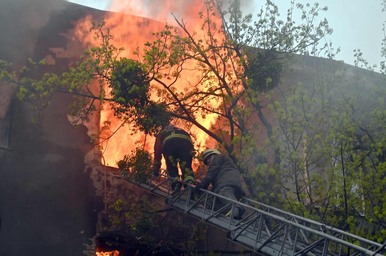 Firefighters try to extinguish a fire in a residential building following bombardment in central Kharkiv on April 17, 2022, amid the Russian invasion of Ukraine. 