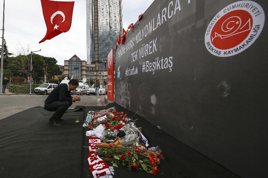 A man prays outside the Besiktas football club stadium Vodafone Arena in Istanbul, Monday, Dec. 12, 2016. Turkey launched a full investigation and bury the dead Monday after two bombings in Istanbul killed dozens of people and wounded score others near Besiktas' stadium. Turkish authorities have banned distribution of images relating to the Istanbul explosions within Turkey.(AP Photo/Emrah Gurel)