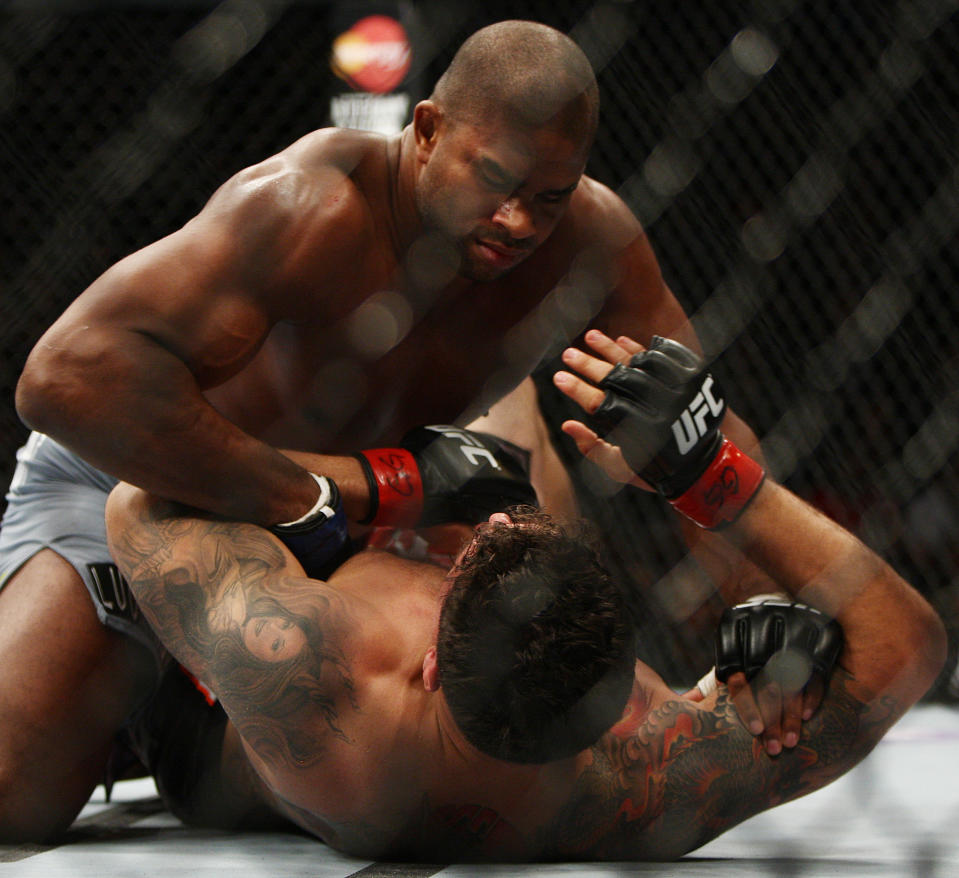 Frank Mir, bottom, and Alistair Overeem, of the Netherlands, fight during the first round of a UFC 169 heavyweight mixed martial arts bout in Newark, N.J., Saturday, Feb. 1, 2014. Overeem won by unanimous decision. (AP Photo/Tim Larsen)