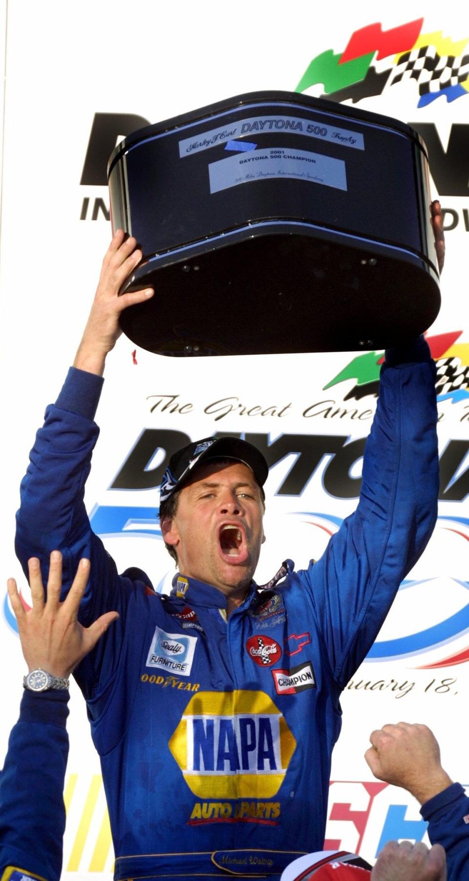 Michael Waltrip lifts the champion's trophy after winning the 2001 edition of the Daytona 500. On Monday, Feb. 12, Waltrip will be a guest bartender at Daytona Beach International Airport. It's an event to announce that brews from the Michael Waltrip Brewing company are now being sold at the airport.