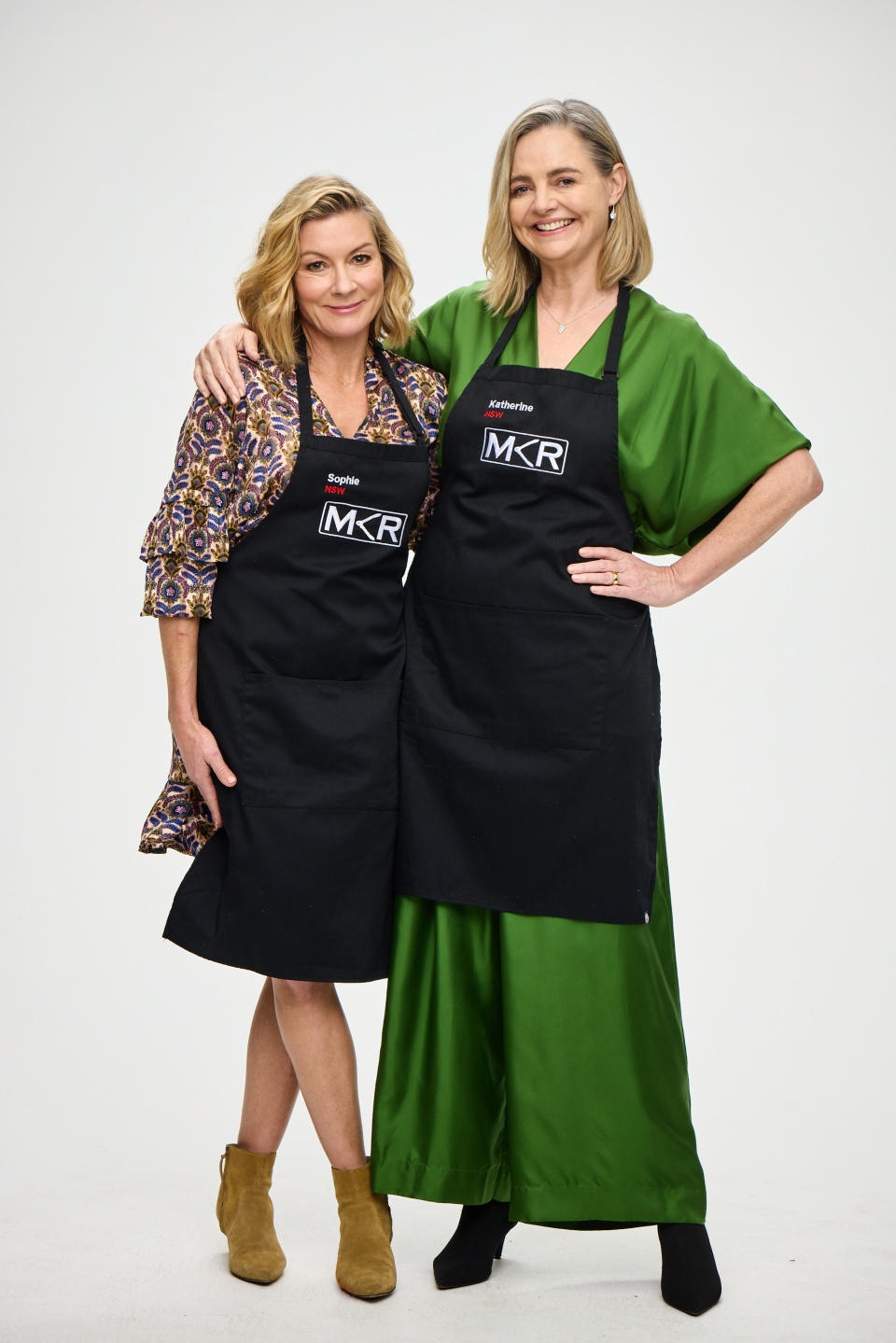 MKR 2022 contestants Katherine and Sophie form NSW stand smiling in MKR aprons