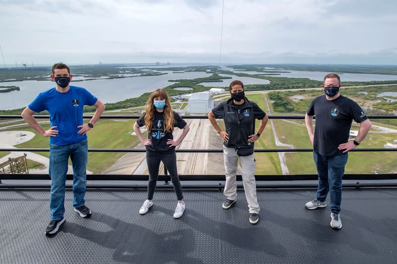 Jared Isaacman, Hayley Arceneaux, Sian Proctor and Chris Sembroski pose for a photo at the SpaceX launch tower at NASA's Kennedy Space Center at Cape Canaveral