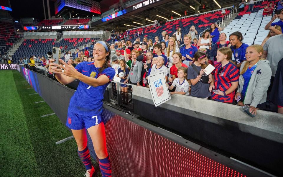 Home field advantage?  Ashley Hatch of the United States takes photos with fans after a game between Ireland and the USWNT in Saint Louis - John Todd/USSF/Getty Images