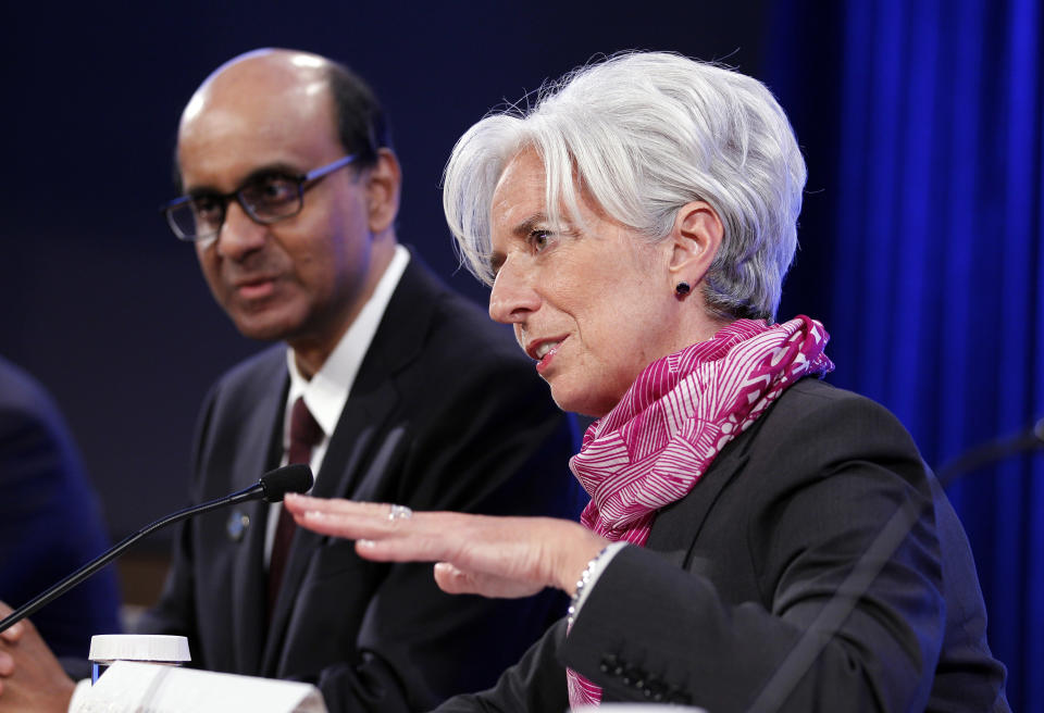 International Monetary Fund (IMF) Managing Director Christine Lagarde and and Singapore Finance Minister Tharman Shanmugaratnam, left, speak during a news conference at the World Bank/IMF Spring Meetings at IMF headquarters in Washington, on Saturday, April, 21, 2012. (AP Photo/Jose Luis Magana)