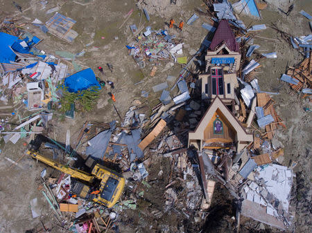 An aerial view of evacuation process near a collapsed church after an earthquake in Sigi, south of Palu, Central Sulawesi, Indonesia, October 4, 2018 in this photo taken by Antara Foto. Antara Foto/Hafidz Mubarak A/ via REUTERS