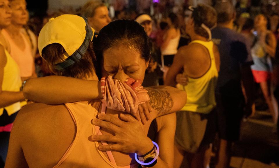 Erica McCarrens, front, hugs a runner who did not want to be named before the Let's Finish Liza's Run event on Friday, Sept. 9, 2022, outside the Cathedral of the Immaculate Conception on Central Avenue in Memphis. The eight mile run was held in honor of Eliza Fletcher, a Memphis mother and teacher who was reportedly abducted while running on the University of Memphis campus. “Our goal is to stand up for the women in the Mid-South and emphasize that women should be able to safely run any time of day,” the Facebook event said. 