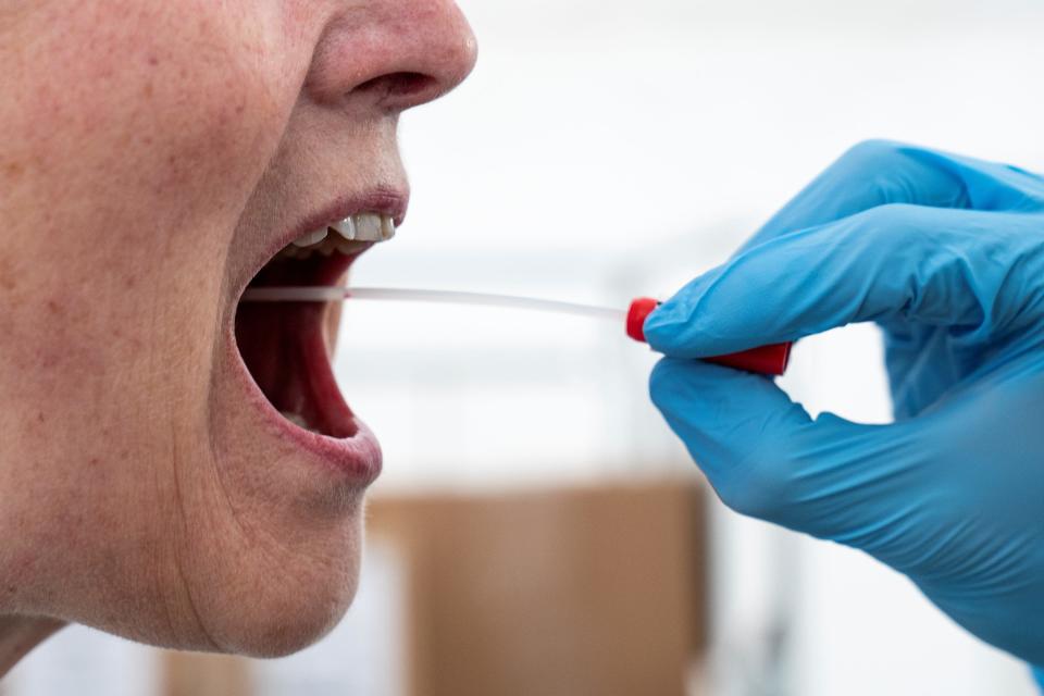 A medical worker performs a mouth swab on a patient to test for the coronavirus disease (COVID-19) in a new tent extension of Danish National Hospital Rigshospitalet in Copenhagen, Denmark (file photo).