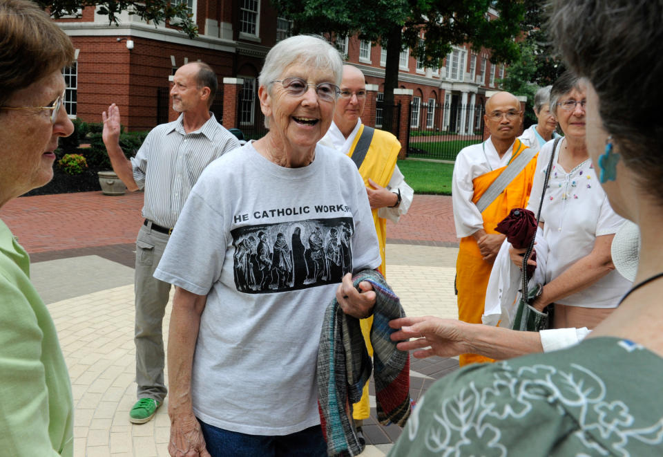 FILE - In this Aug. 9, 2012, file photo, Sister Megan Rice, center, and Michael Walli, in the background waving, are greeted by supporters as they arrive for a federal court appearance in Knoxville, Tenn. The two nuclear protester and a third defendant, Greg Boertje-Obed, are scheduled to be sentenced on Tuesday, Jan. 28, 2014 for their incursion into the Y-12 National Security Complex in Oak Ridge, Tenn ., in 2012. (AP Photo/Knoxville News Sentinel, Michael Patrick, file