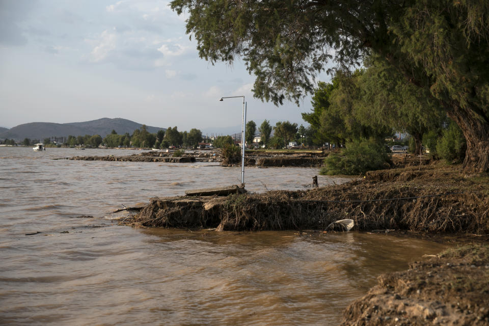 A damaged shoreline following a storm at the village of Bourtzi, on Evia island, northeast of Athens, on Sunday, Aug. 9, 2020. Five people, including en elderly couple and an 8-month-old baby have been found dead, two more are missing and dozens have been trapped in their homes and cars as a storm hits the island of Evia in central Greece, authorities said Sunday. (AP Photo/Yorgos Karahalis)