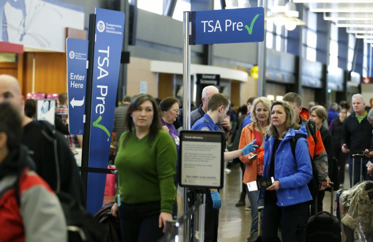 Travelers authorized to use the Transportation Security Administration's PreCheck expedited security line at Seattle-Tacoma International Airport in Seattle have their documents checked by TSA workers on March 17, 2016. (Photo/Ted S. Warren/AP)