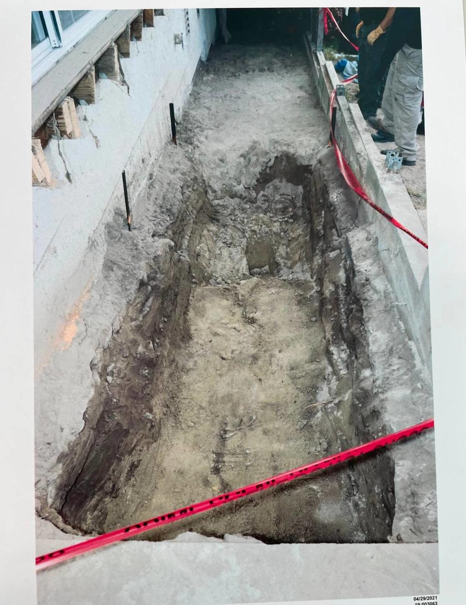 A photo of the soil disturbance found underneath Ruben Flores’ deck is shown to jurors overseeing the Kristin Smart murder trial at Monterey County Superior Court on Sept. 1, 2022. The photo depicts the hole in the middle of the digging process.