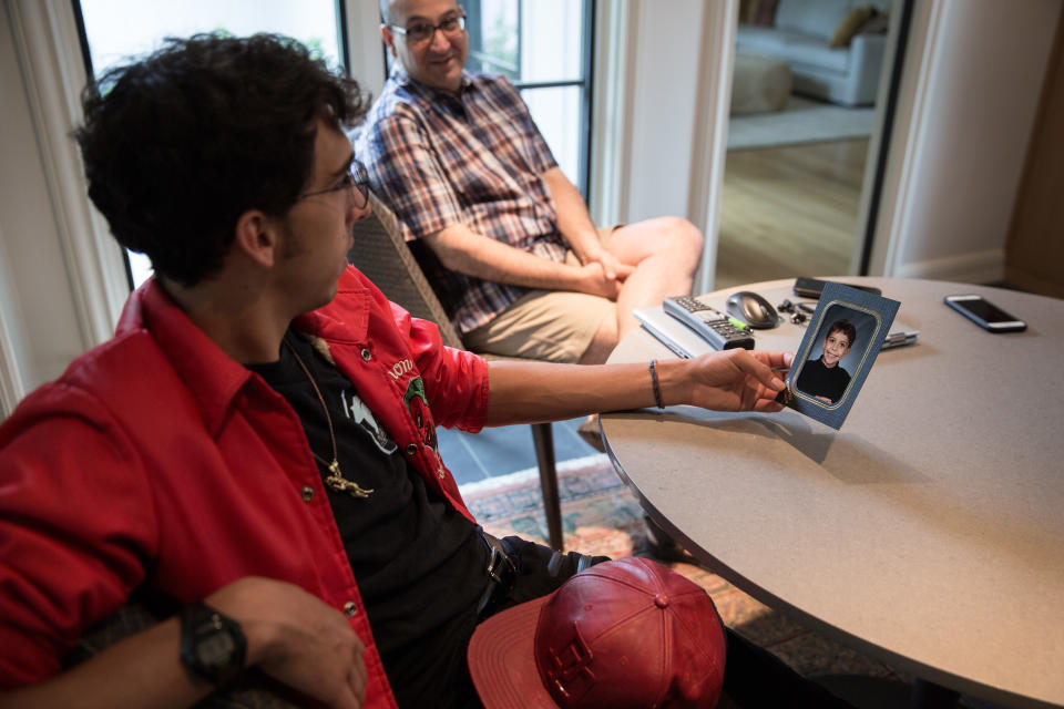 Michael Matt looks at a photo of himself as a child that his father, Andrew, has brought out to show him, on June 24, 2018, in Providence, R.I. (Photo: Kayana Szymczak for Yahoo News)